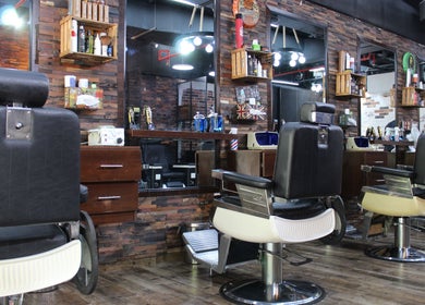 Interior of Tornado Gents Salon - JLT in Dubai, AE, featuring stylish barber chairs and a rustic decor.