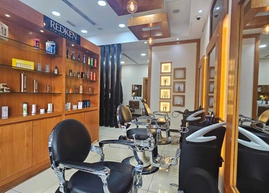 Chic interior of Tornado Gents Salon - Marina, Dubai, Dubai, AE, featuring sleek barber chairs and product displays.