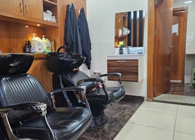 Modern hairdressing area at Tornado Gents Salon - Marina, Dubai, Dubai, AE with sleek chairs and wash basins.