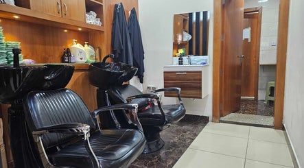Modern hairdressing area at Tornado Gents Salon - Marina, Dubai, Dubai, AE with sleek chairs and wash basins.