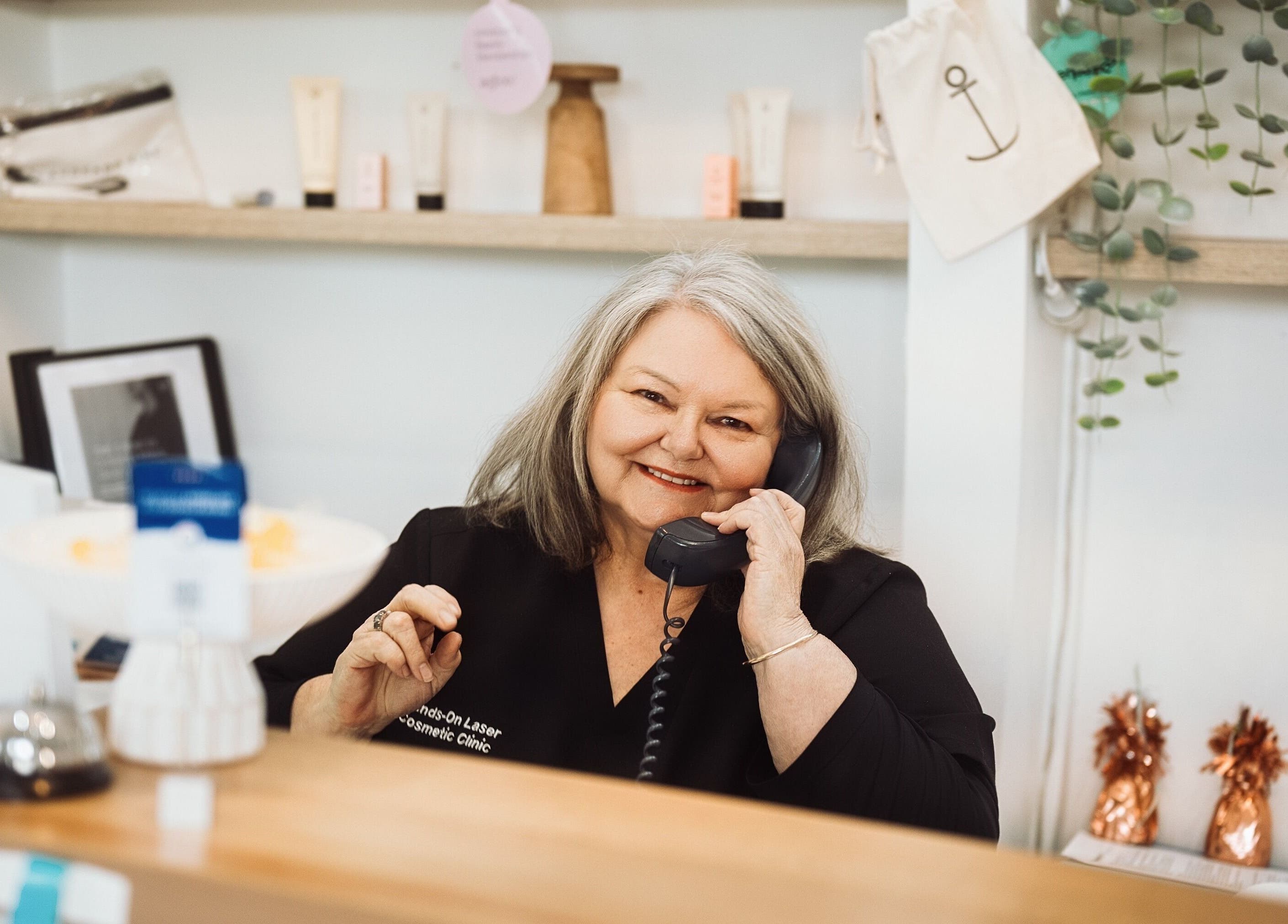 Receptionist at Hands-On Laser Cosmetic Clinic in Melbourne, Victoria, AU, speaking on the phone.