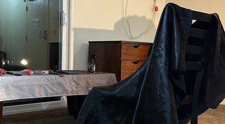 Haircut station at FT Cuts in Sylvania, Ohio, US, featuring tools and a sleek black cape.