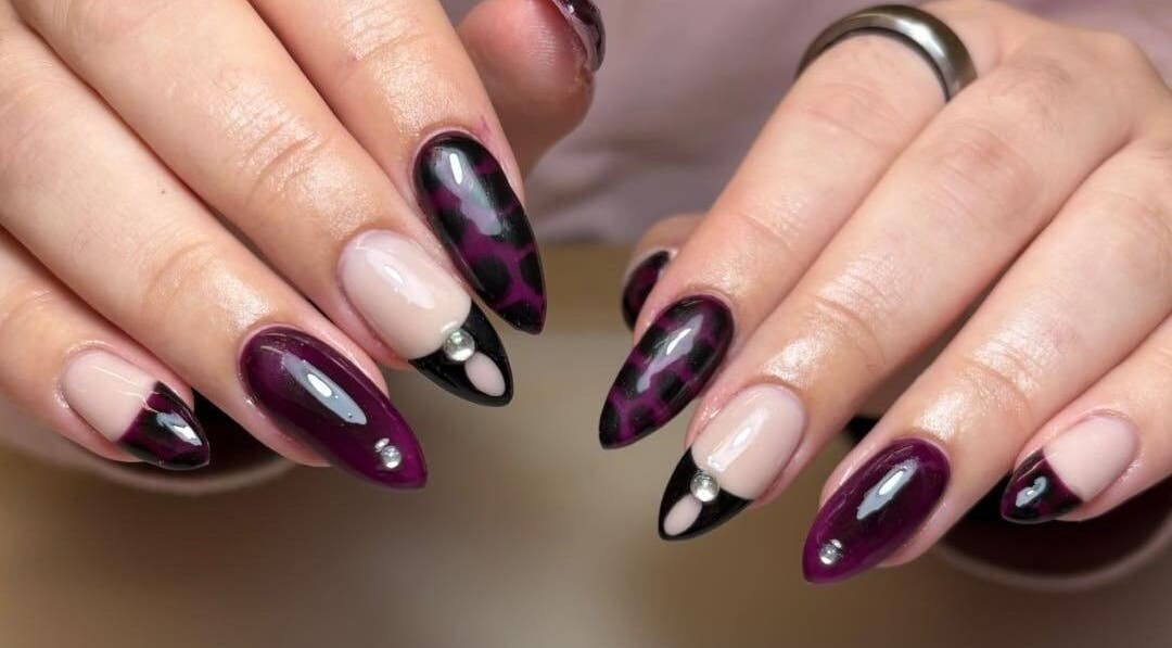 Elegant plum and black nail art with gems by Nails by Jamie Holt, Halfway, England, GB.