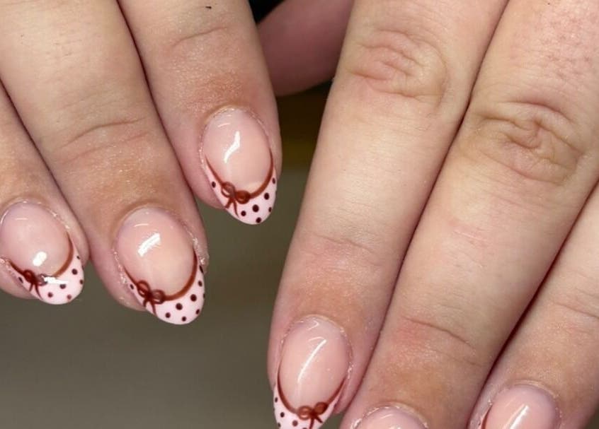 Polka dot nail art at Nails by Jamie Holt, Halfway, England, GB. Features pink base with brown dots and bows.