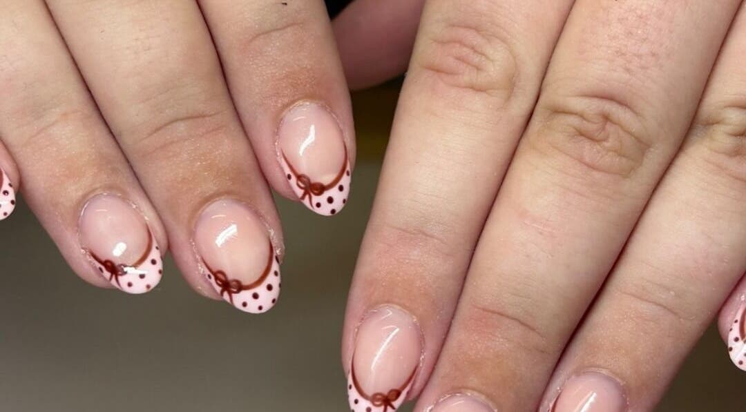 Polka dot nail art at Nails by Jamie Holt, Halfway, England, GB. Features pink base with brown dots and bows.