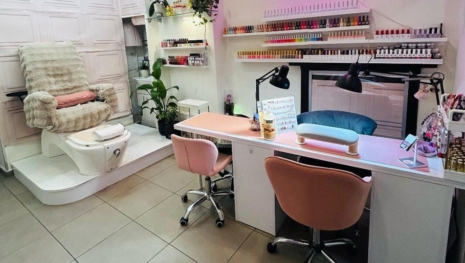 Modern nail salon setup at Jb_beautyhub_ in Lagos, Lagos, NG with cozy chairs and nail polish display.