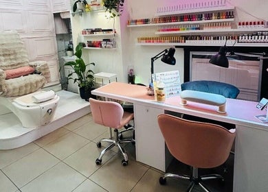 Modern nail salon setup at Jb_beautyhub_ in Lagos, Lagos, NG with cozy chairs and nail polish display.