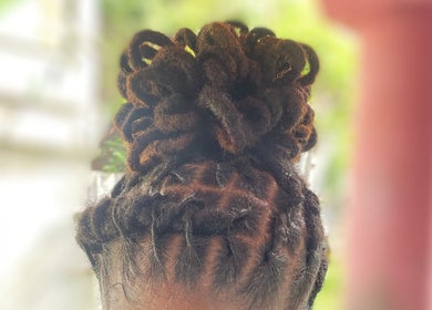 Intricate locs updo at Mimi’s Touch, St.Joseph, Saint Joseph Parish, DM, showcasing expert hairstyling.