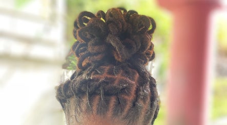 Intricate locs updo at Mimi’s Touch, St.Joseph, Saint Joseph Parish, DM, showcasing expert hairstyling.