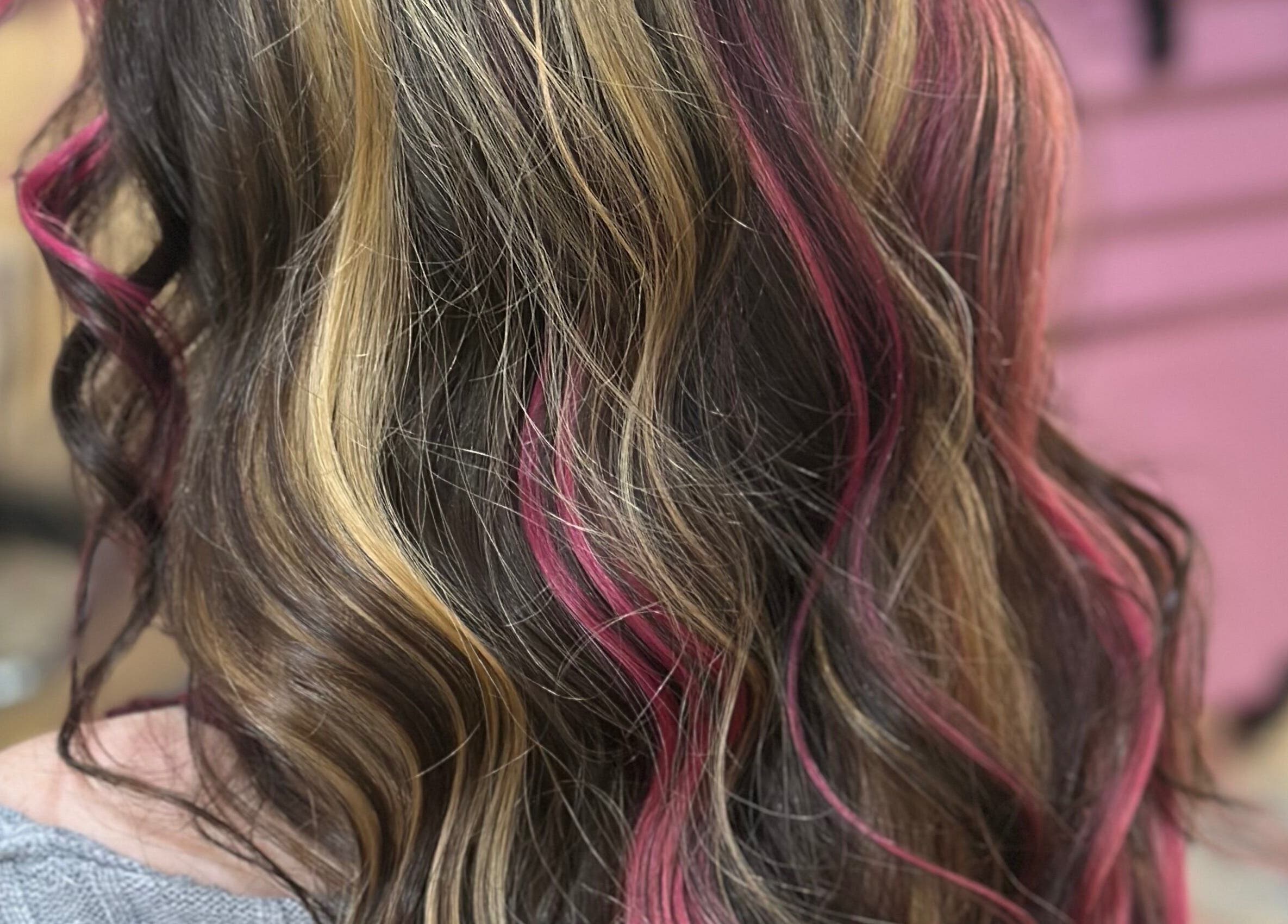 Stylish hair with pink highlights at Hair By Em in Choudrant, Louisiana, US.