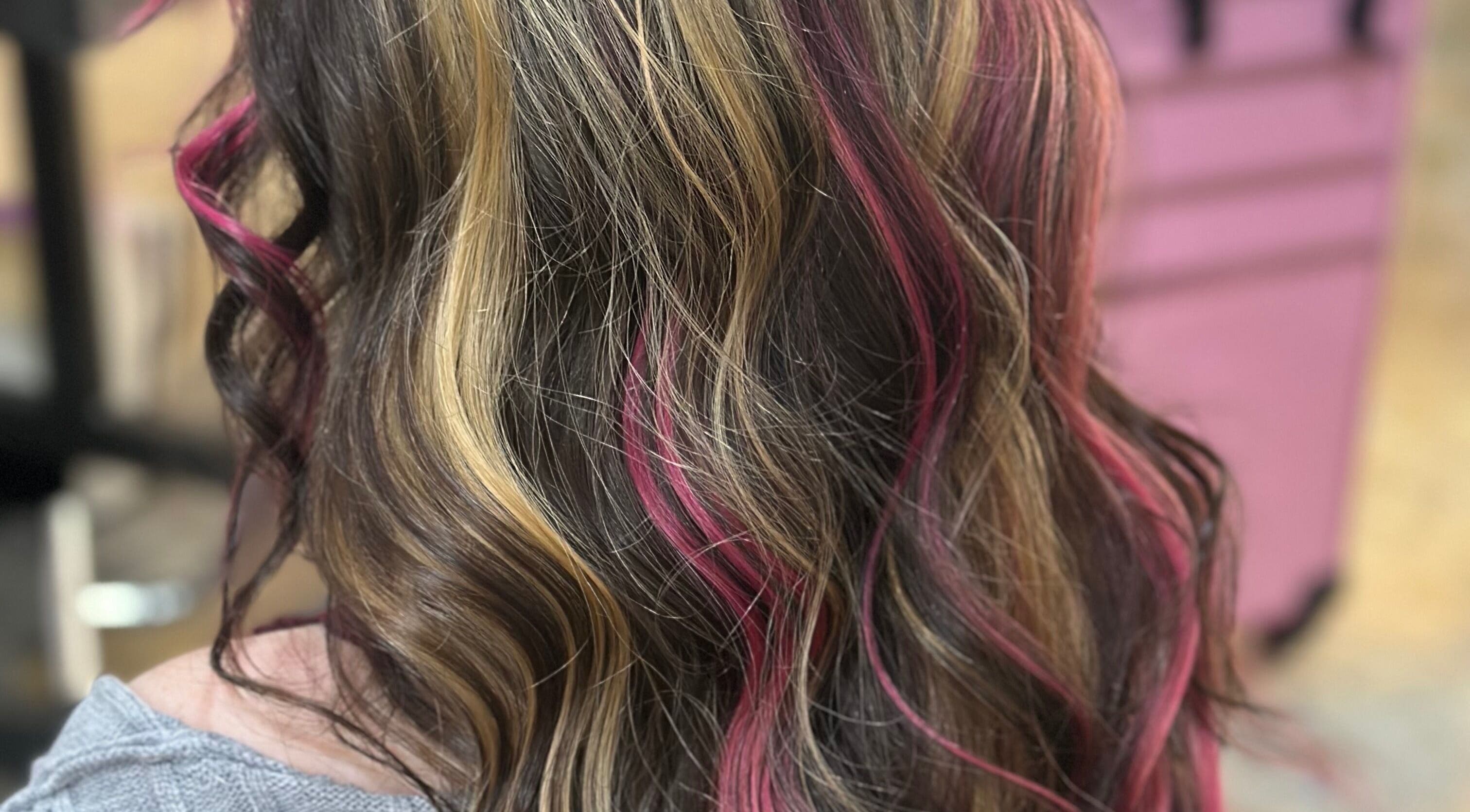 Stylish hair with pink highlights at Hair By Em in Choudrant, Louisiana, US.