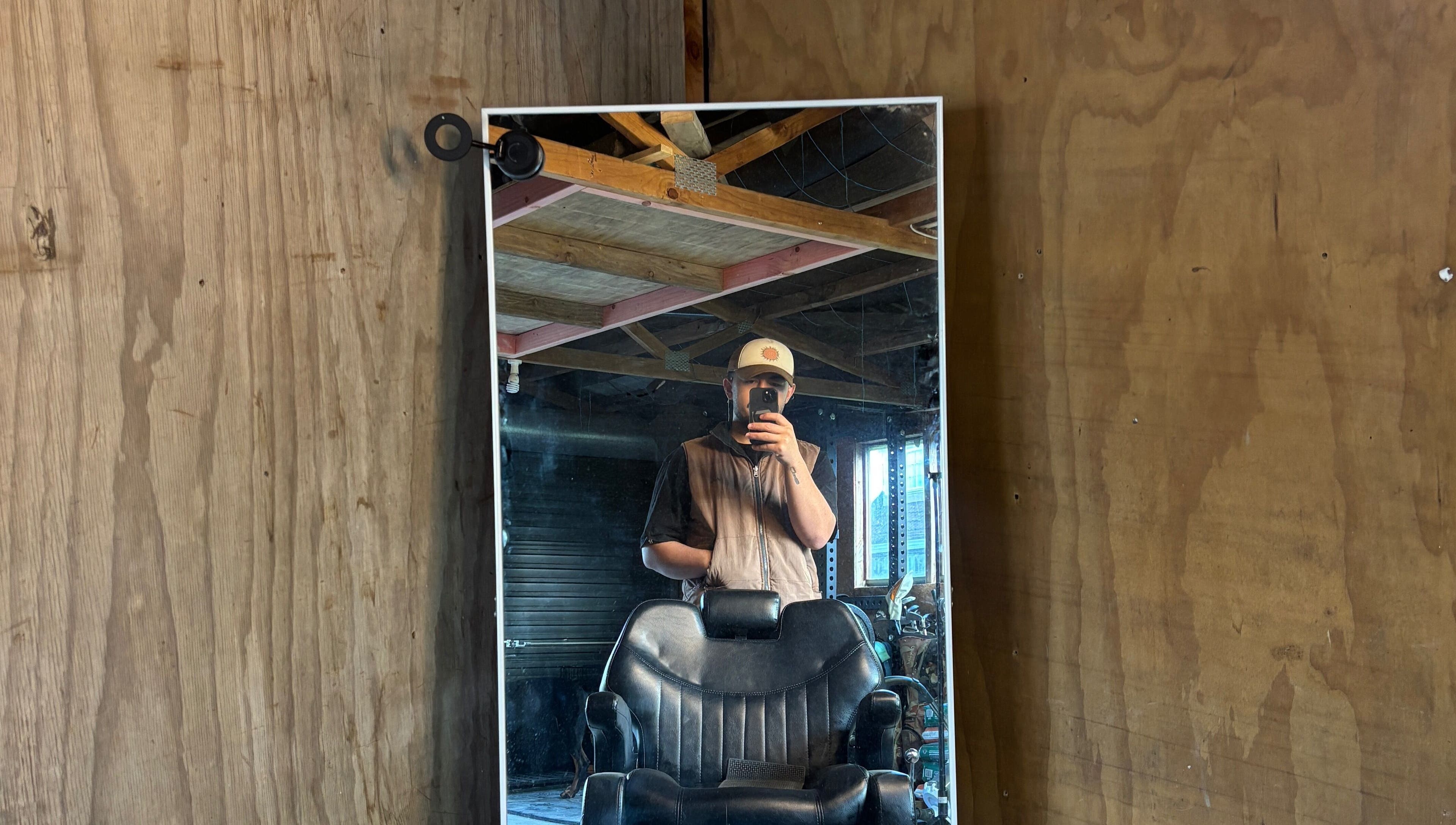Rustic barber chair and mirror setup at Rubin Karere, Hamilton, Waikato Region, NZ reflecting a cozy ambiance.