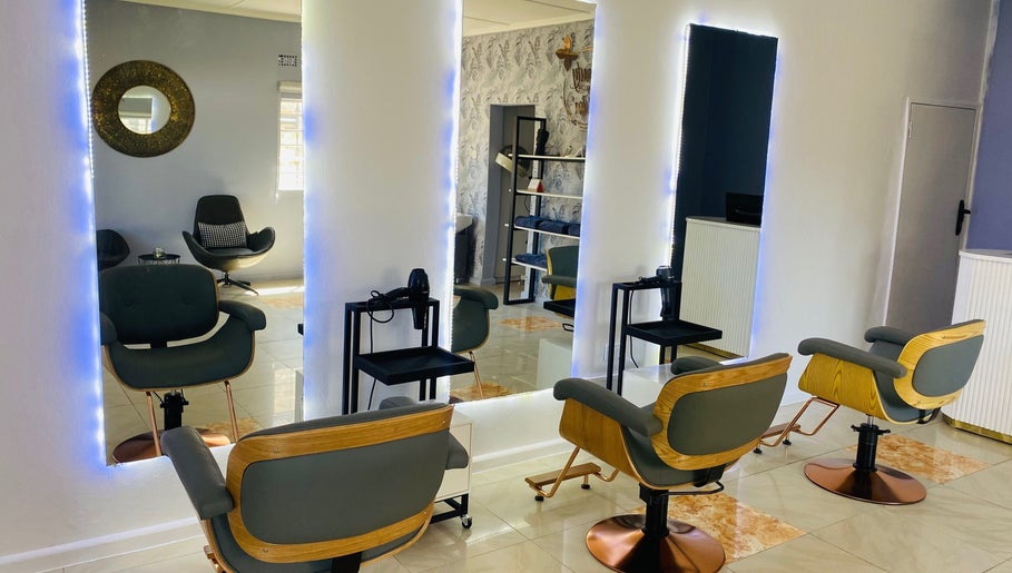 Modern salon interior at Beauty By Moi, Lusaka, Lusaka Province, ZM with stylish chairs and mirrors.
