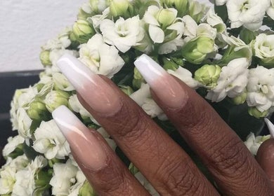 Stylish acrylic nails with white tips and flowers at Glam Guru, Sandton, Gauteng, ZA.