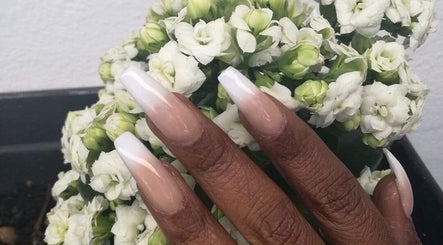 Stylish acrylic nails with white tips and flowers at Glam Guru, Sandton, Gauteng, ZA.