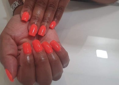 Bright orange manicured nails at Glam Guru, Sandton, Gauteng, ZA.