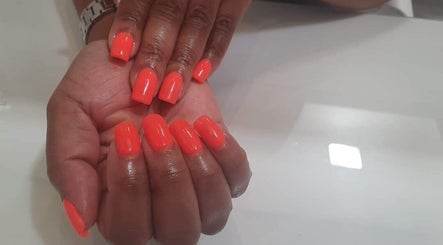 Bright orange manicured nails at Glam Guru, Sandton, Gauteng, ZA.