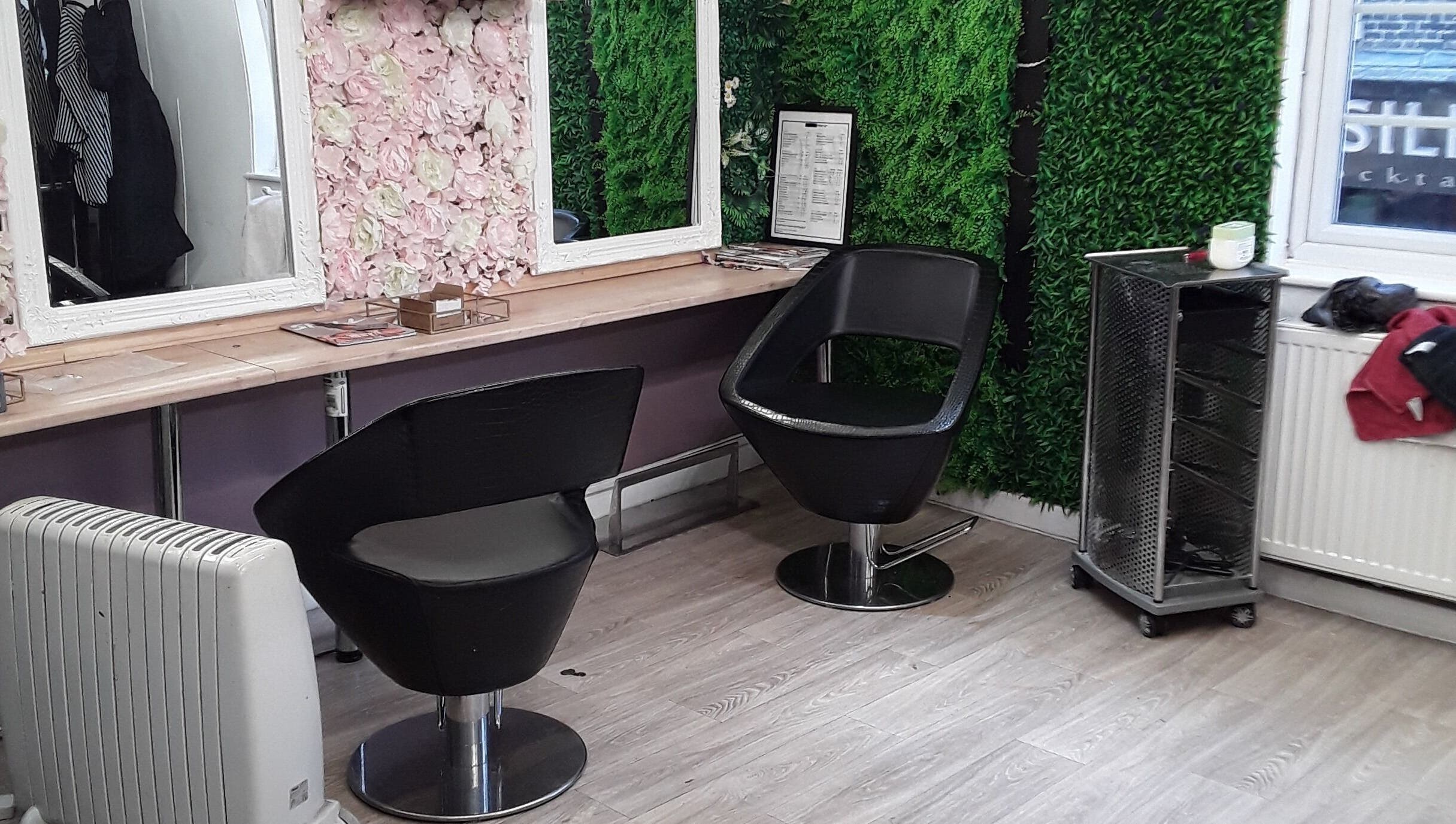 Chic styling area at Nu-trendz hair and beauty ltd, Colchester, England, GB with floral and green decor.