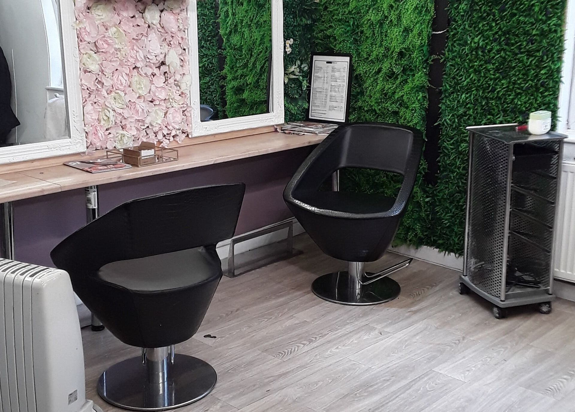 Chic styling area at Nu-trendz hair and beauty ltd, Colchester, England, GB with floral and green decor.