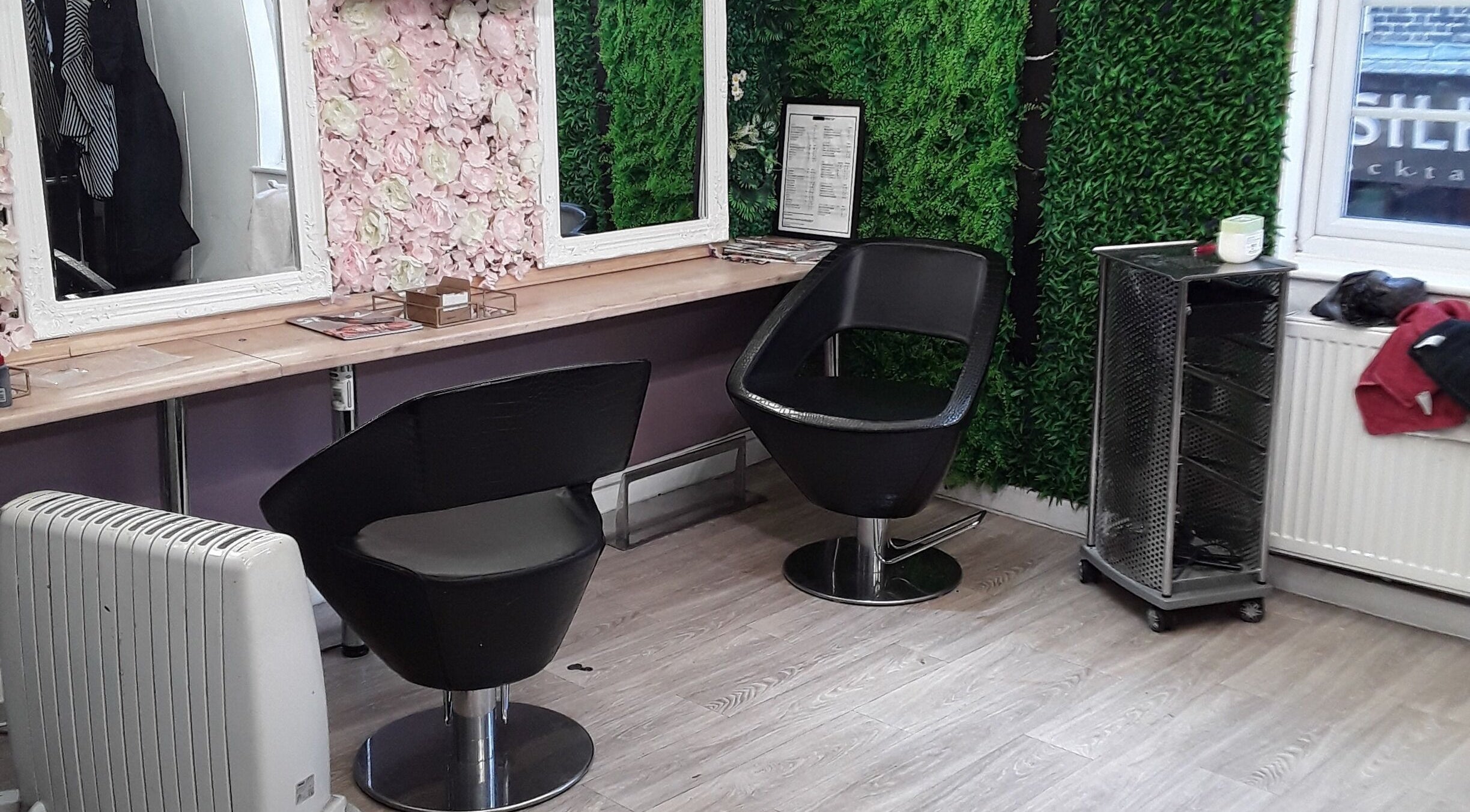 Chic styling area at Nu-trendz hair and beauty ltd, Colchester, England, GB with floral and green decor.