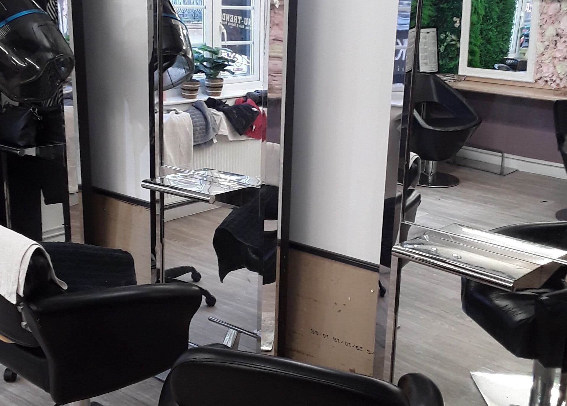 Modern salon interior of Nu-trendz Hair and Beauty Ltd, Colchester, England, GB with sleek styling chairs.