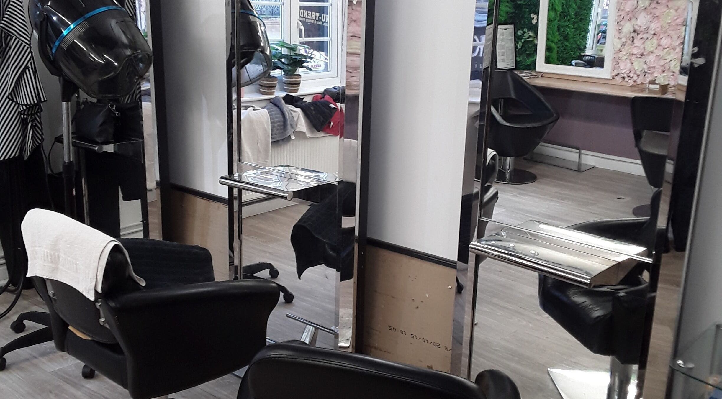 Modern salon interior of Nu-trendz Hair and Beauty Ltd, Colchester, England, GB with sleek styling chairs.