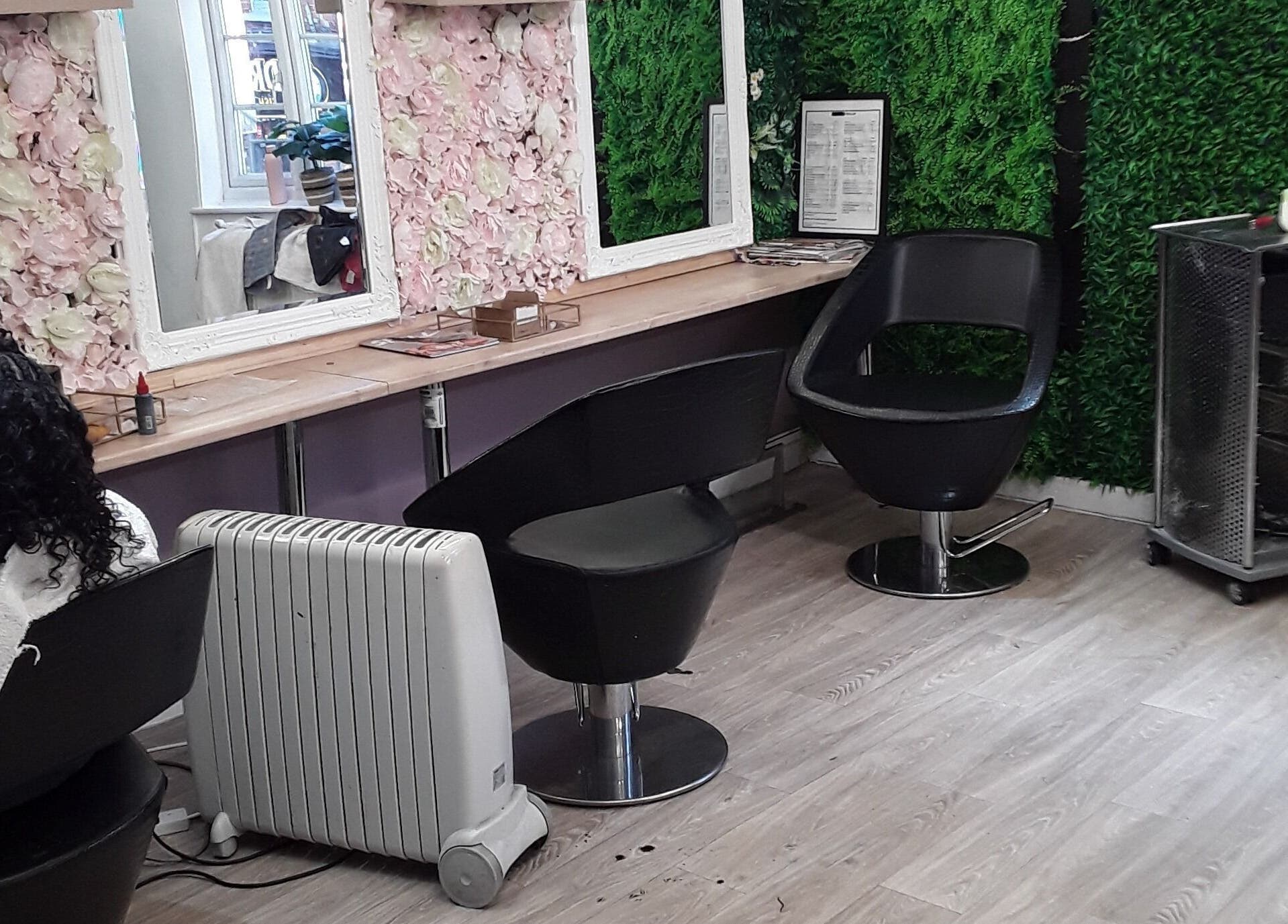 Stylish salon interior at Nu-trendz Hair and Beauty Ltd in Colchester, England, GB with floral decor and modern seating.