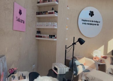 Cozy nail salon at Sakura Spa in Al Khobar, Eastern Province, SA with plush chairs and nail polish display.