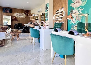 Elegant beauty and wellness salon, Kazachok, Sofia, Sofia City Province, BG with teal seating and floral walls.