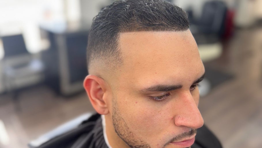 Customer with a sleek fade haircut at First Klass Barbershop, Trenton, New Jersey, US.