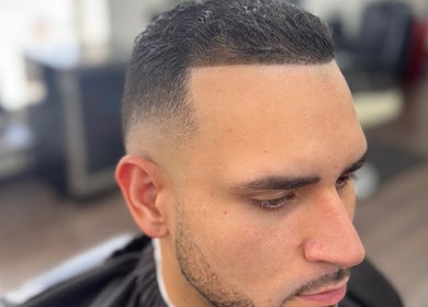 Customer with a sleek fade haircut at First Klass Barbershop, Trenton, New Jersey, US.