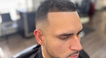 Customer with a sleek fade haircut at First Klass Barbershop, Trenton, New Jersey, US.