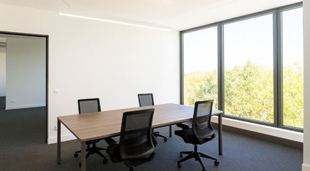 Bright meeting room at Retha Spa, Johannesburg, Gauteng, ZA with large windows and modern chairs.