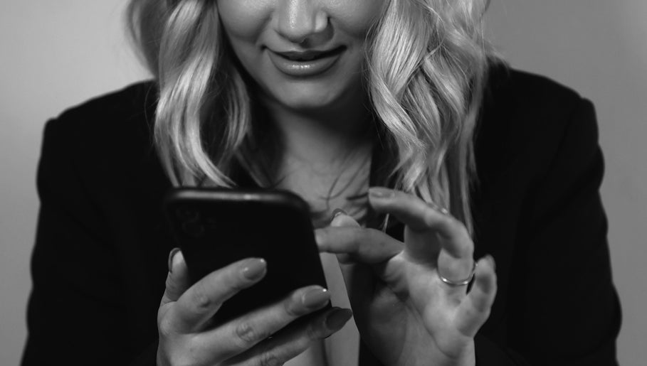 Client scheduling an appointment at Kylie’s Beauty Studio, Cape Town, Western Cape, ZA on mobile phone.