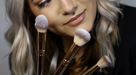 A stylist at Kylie’s Beauty Studio in Cape Town showcasing premium makeup brushes for flawless applications.