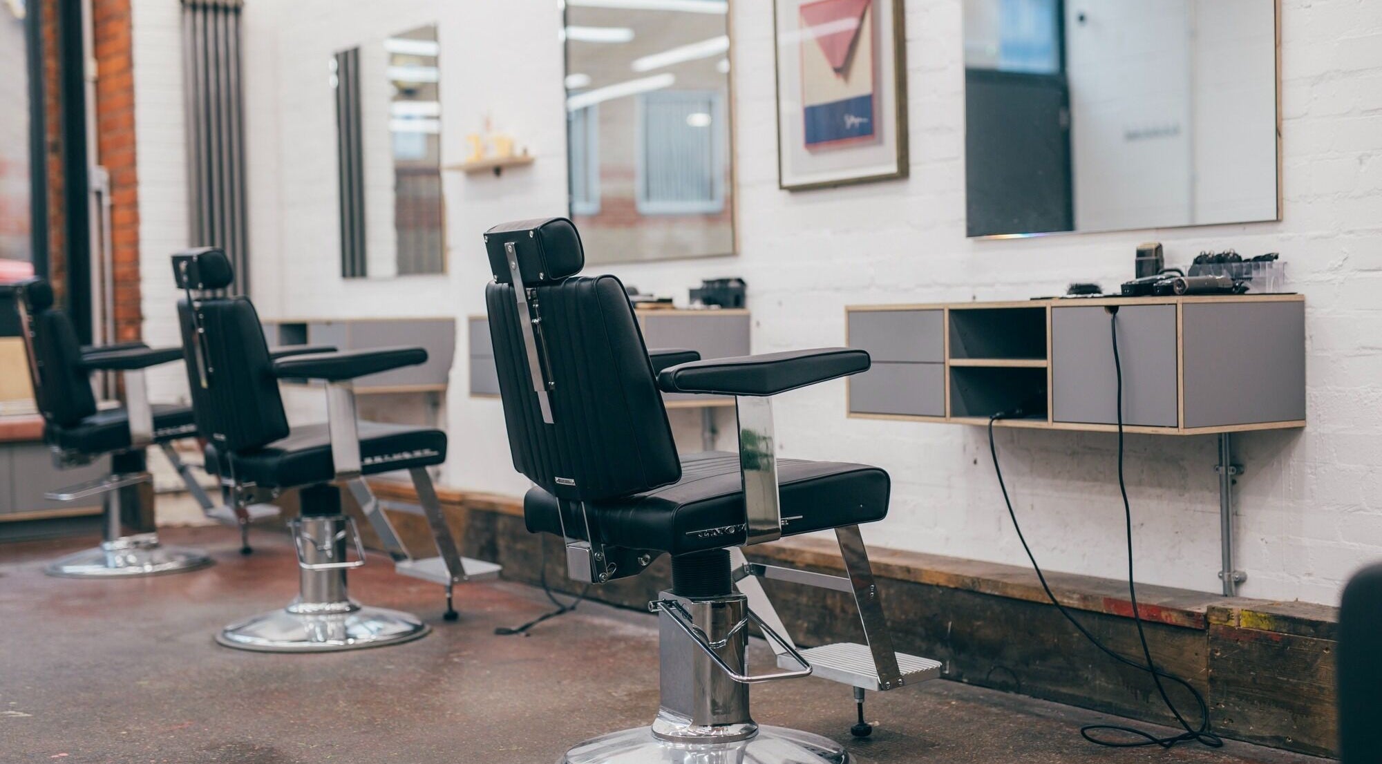 Modern salon chairs at Nudo Studio, London, England, GB, showcasing sleek interior design.