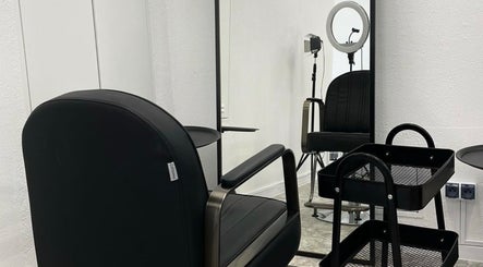 Nowoczesne wnętrze Lena’s Silk Studio na Żelazna, Województwo Opolskie, PL. Czarny fotel i lustro.