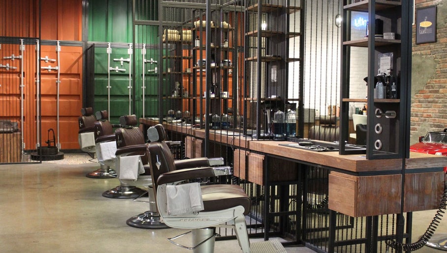 Modern barber chairs at Hair District Barbershop in Dubai, Dubai, AE, showcasing sleek interior design.