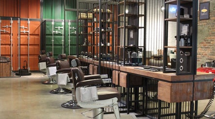 Modern barber chairs at Hair District Barbershop in Dubai, Dubai, AE, showcasing sleek interior design.