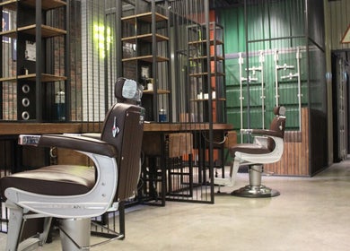 Elegant barber chair at Hair District Barbershop, Dubai, Dubai, AE, showcases modern style and comfort.