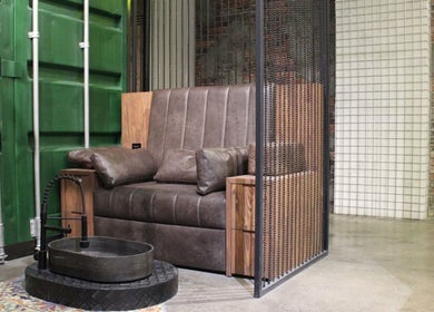 Luxurious leather seating in Hair District Barbershop, Dubai, Dubai, AE, featuring modern industrial style.