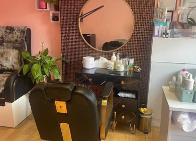 Stylish salon setup at V-NAILS, Richmond, England, GB, featuring a plush chair and modern decor.