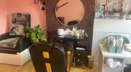 Stylish salon setup at V-NAILS, Richmond, England, GB, featuring a plush chair and modern decor.