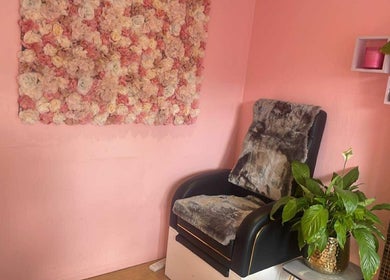 V-NAILS cozy chair with floral decor in Richmond, England, GB, offering a serene beauty experience.