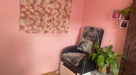 V-NAILS cozy chair with floral decor in Richmond, England, GB, offering a serene beauty experience.