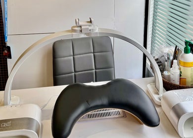 Nail care station at V-NAILS in Richmond, England, GB, featuring modern equipment and comfortable seating.