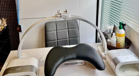 Nail care station at V-NAILS in Richmond, England, GB, featuring modern equipment and comfortable seating.