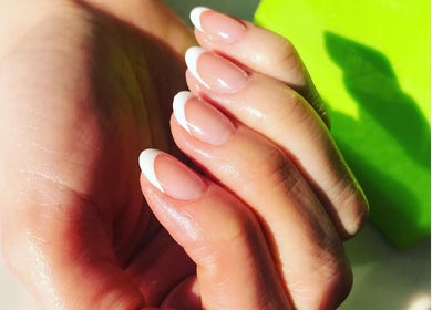 Close-up of elegant French manicure at V-NAILS, Richmond, England, GB showcasing pristine white tips.