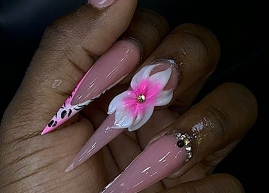 Elegant floral nails designed at Nailssxtam, Princes Town Regional Corporation, TT. Stylish art with gems and patterns.
