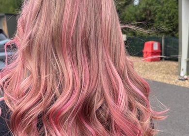 Pink wavy hairstyle from Luna Hair, Redditch, England, GB. Vibrant color and styling showcase expert technique.